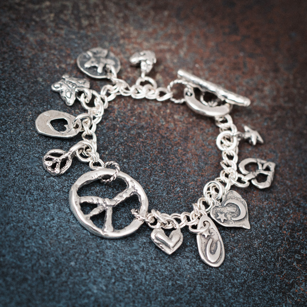 charm bracelet with peace signs and hearts
